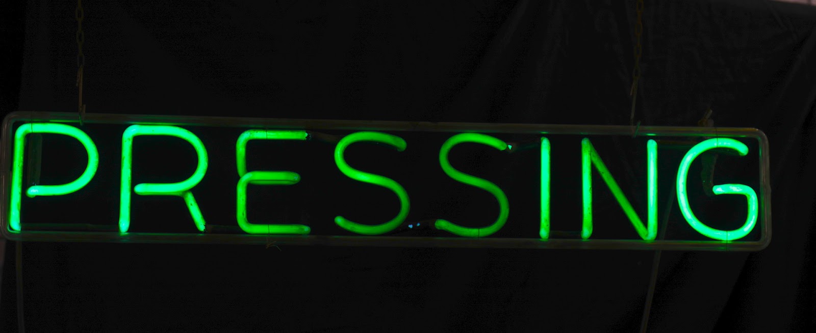 PRESSING neon sign